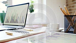 Workplace of a businessman. Desk with a laptop, tablet, notebook and other accessories.