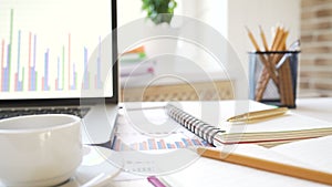 Workplace of a businessman. Desk with a laptop, tablet, notebook and other accessories.