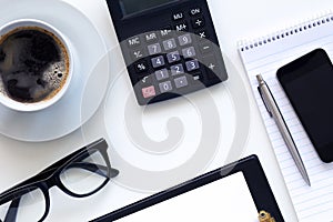 Workplace, coffee and diary with calculator