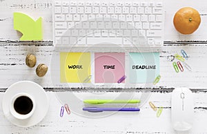 a workplace with colorful, motivating, saved cards. Concept, project deadline. Keyboard, healthy snack, pens, bright background.