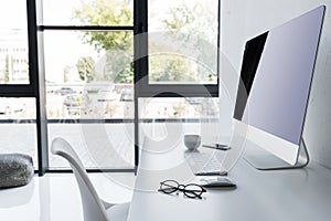 workplace with computer on white table