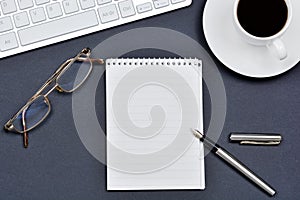 Workplace with a cup of coffee, notepad and keyboard computer