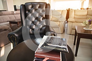 The workplace of the director of a furniture store with an expensive leather armchair, a sofa table and several catalogs