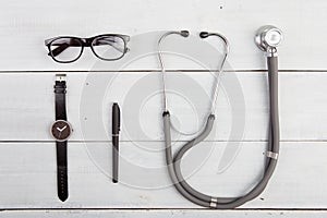 Workplace of doctor - stethoscope, glasses and watches