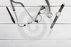 Workplace of doctor - stethoscope, glasses and watches