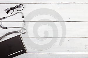 Workplace of doctor - stethoscope, notepad, glasses