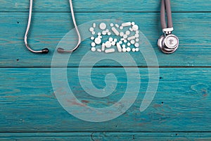 Workplace of doctor - stethoscope and pills