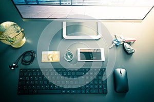 Workplace of a freelancer with computer, keyboard, credit card and compass