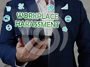 WORKPLACE HARASSMENT text in search line. Budget analyst looking for something at computer. WORKPLACE HARASSMENT concept