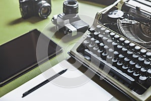 Workplace Of A Journalist, Writer, Blogger. Analog Typewriter, Digital Tablet And Film Camera On The Green Table