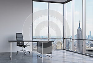 A workplace in a modern corner panoramic office in New York, Manhattan. A black leather chair and a black table. A concept of fina