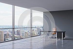 A workplace in a modern corner panoramic office in New York, Manhattan. A brown leather chair and a black table.