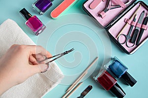 Workplace in a nail salon. A set of tools for hand care on blue background. Place for text.