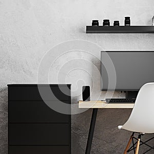 Workplace with PC on loft style wooden table with white chair, black chest of drawers and empty gray wall, work from home concpet