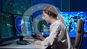 Workplace of the professional air traffic controller in the control tower. Female aircraft control officer works using