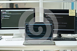 Workplace of programmer with computers with codes
