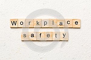 workplace safety word written on wood block. workplace safety text on table, concept