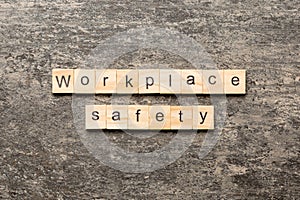 workplace safety word written on wood block. workplace safety text on table, concept