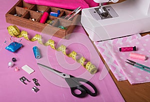 The workplace of seamstress. Cut-outs of colorful fabrics, accessories for sewing, sewing machine