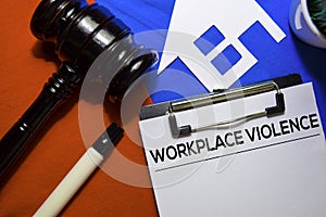 Workplace Violence text on Document form and Gavel isolated on office desk.