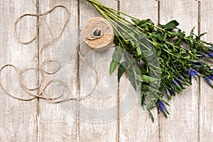 Workplace with wildflower and rope flat lay