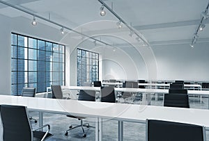 Workplaces in a bright modern loft open space office. Empty tables and docents' book shelves. Singapore panoramic view. A concept