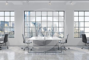 Workplaces in a bright modern loft open space office. Tables are equipped with modern computers. New York panoramic view. A concep