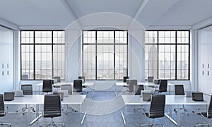 Workplaces in a bright modern open space loft office. White tables equipped with modern laptops and black chairs. New York panoram