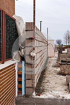 Works of construction of reinforced concrete block wall with ins
