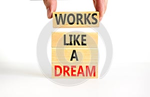 Works like a dream symbol. Concept words Works like a dream on wooden cubes. Beautiful white table white background. Businessman