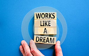 Works like a dream symbol. Concept words Works like a dream on wooden cubes. Beautiful blue table blue background. Businessman