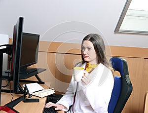 She works in an office on a computer. 1