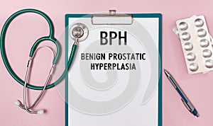 Worksheet with the inscription BPH - Benign Prostatic Hyperplasia, stethoscope and pills