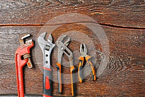 Workshop bench. Variety of hand tools on a wooden table, top view, copy space