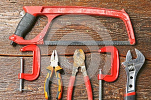 Workshop bench. Variety of hand tools on a wooden table, top view, copy space