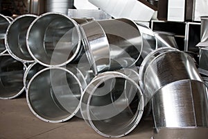 Ventilation metal pipes are a large number in the workshop. photo