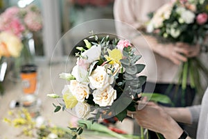 Workshop florist, making bouquets and flower arrangements. Woman collecting a bouquet of flowers. Soft focus