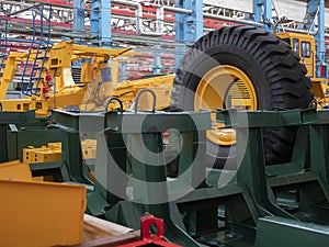 Workshop of machine-building plant. Huge wheel and different metal components and assemblies