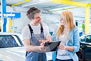 Workshop mechanic handing over car to client