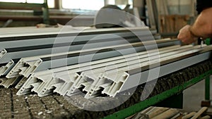 Workshop for the production of PVC windows, the male worker twists the in the PVC profile for further assembly of