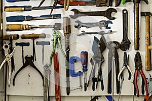 Workshop scene. Old tools shelf against a table and wall