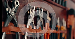 Workshop, tools and wall with equipment on shelf at a workplace for maintenance and creativity. Set of metal objects on