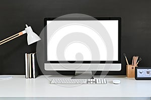 Workspace blank screen desktop computer, Mockup computer, lamp and home office accessories on white desk photo