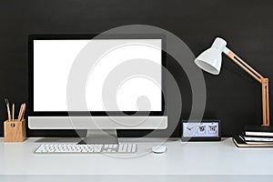 Workspace blank screen desktop computer, Mockup computer, lamp and home office accessories on white desk