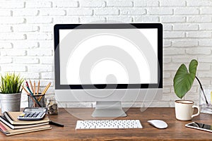 Workspace with computer with blank white screen, and office supplies on wooden desk