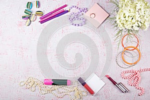 Workspace with computer, bouquet Hydrangeas, clipboard. Women`s fashion accessories on pink background. Flat