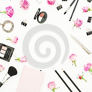 Workspace with cosmetics, accessories and pink roses on white background. Top view. Flat lay. Beauty blog background with copy spa