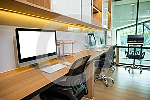 Computer desktop blank screen in front of window in office