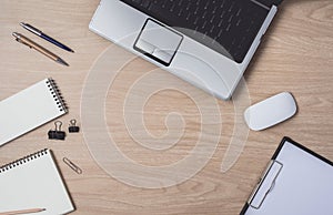 Workspace with diary or notebook and clipboard, laptop, mouse computer, keyboard, pencil, pen on wooden background