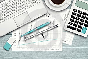 Workspace with graph, computer, graph, calculator and stationery